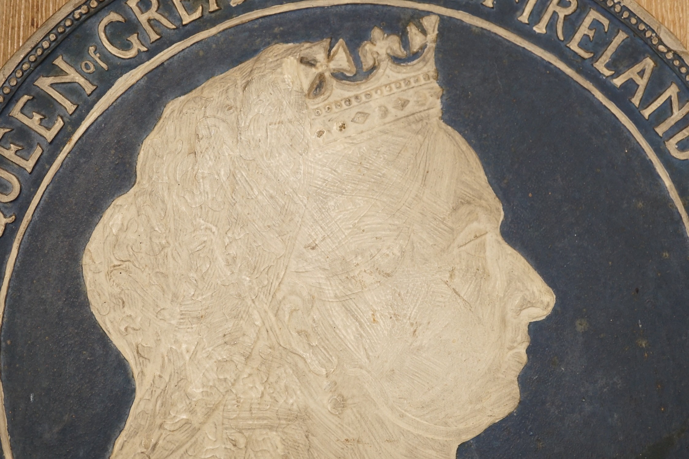 An 18th century carved oak panel together with a commemorative rounded ‘presented by the British and foreign school society to Florence Edith May, pupil in Stockwell College Practicing School to commemorate the completio